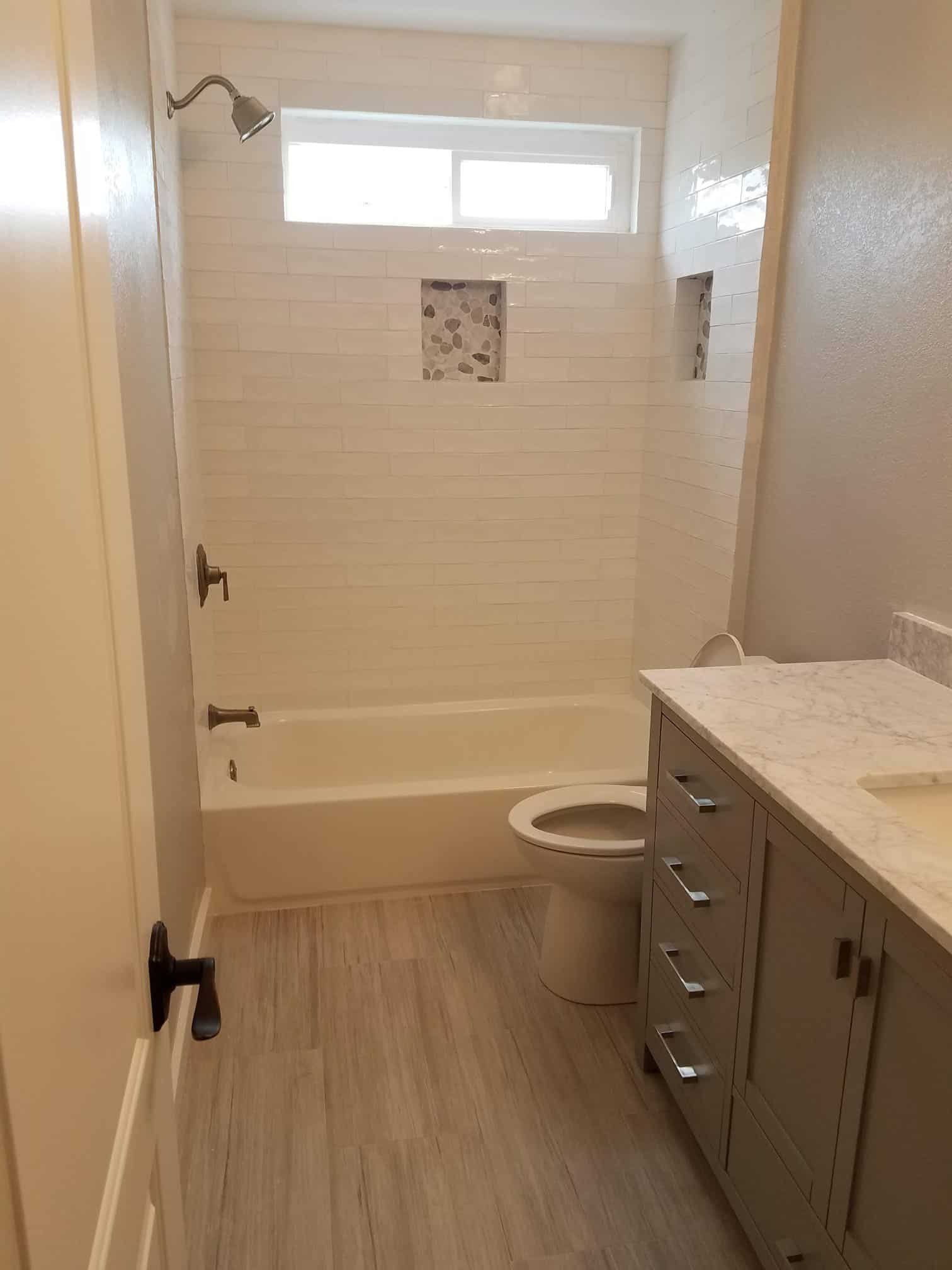 Contemporary bathroom with bathtub, shower, and vanity.