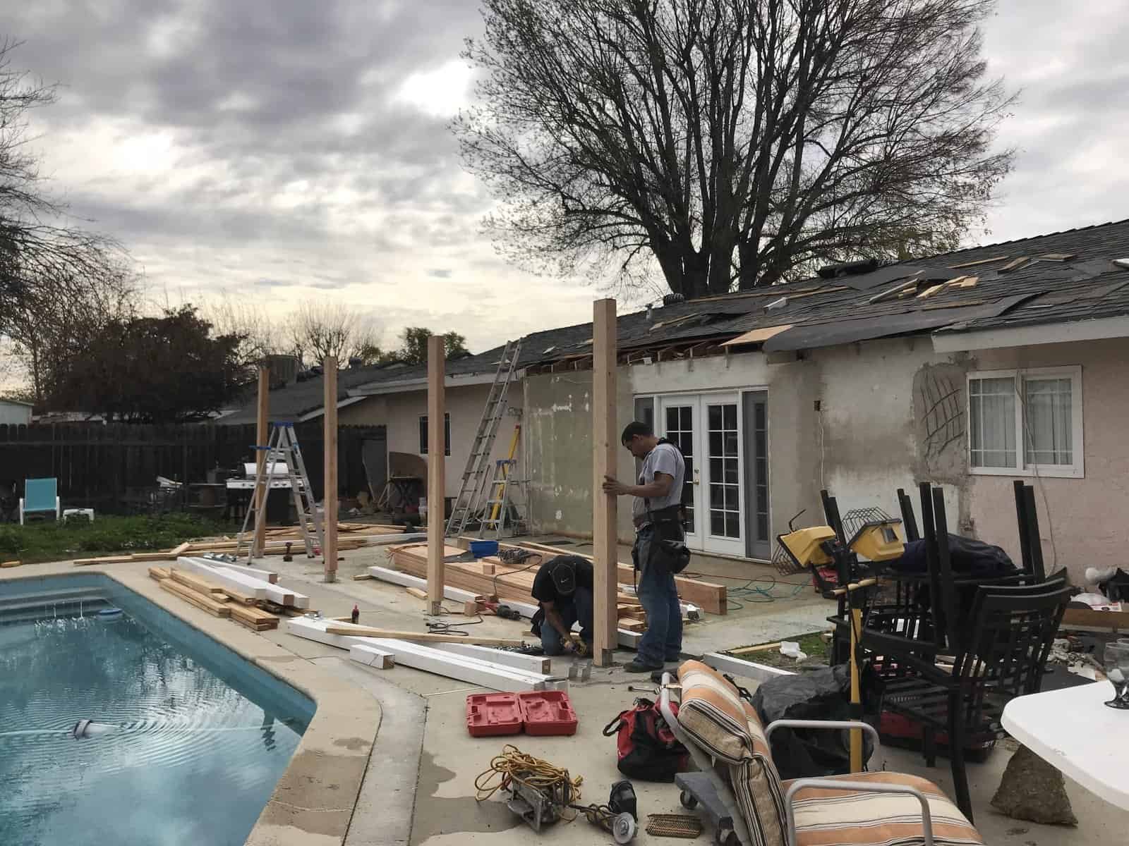 Construction workers building a backyard extension at home.