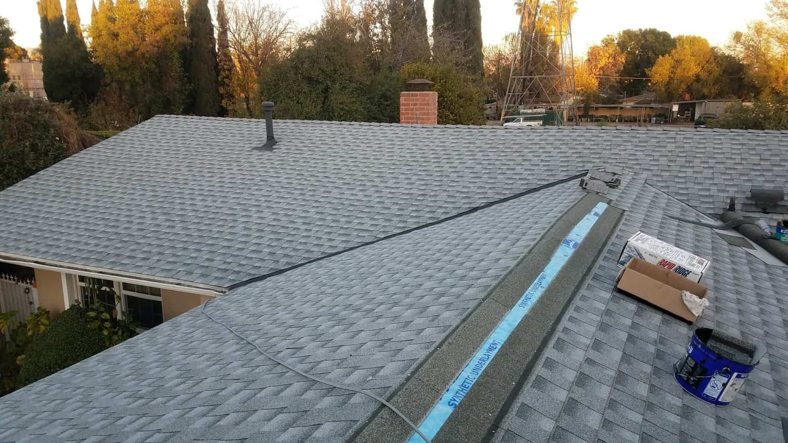 Roof installation with shingles and tools by MDM PRO BUILD.